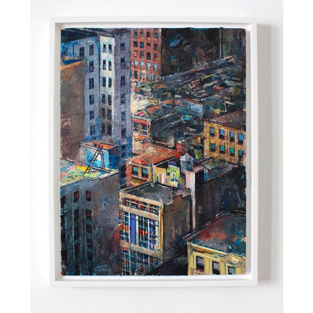 This mixed media piece on wood panel presents a vibrant aerial view of an urban landscape, where buildings and rooftops...
