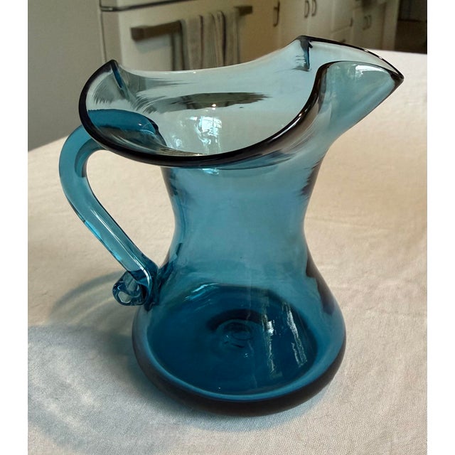 A little piece of West Virginia sky on your shelf. This sweet hand-blown mini pitcher — or creamer — comes from the...