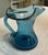 A little piece of West Virginia sky on your shelf. This sweet hand-blown mini pitcher — or creamer — comes from the...