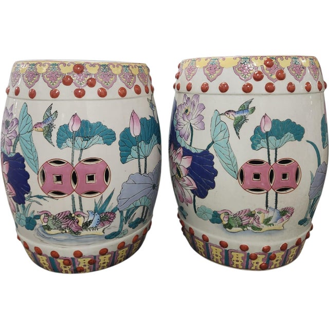 Striking pair of vintage Chinese porcelain garden stools richly decorated in a vibrant Famille Rose palette with lotus...