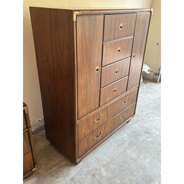 Vintage Drexel Accolade campaign highboy with a warm walnut finish, recessed brass pulls, and a tall, sturdy silhouette....