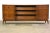 A mid century modern walnut dresser with sculpted details. Original finish is in excellent condition. 73.5” wide. 19”...