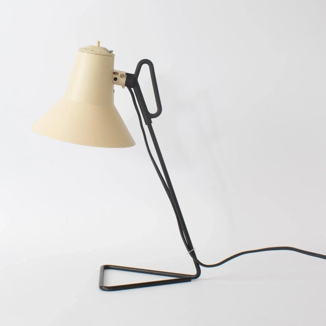 Lampshade moves sideways. Lamp uses one bulb, type E14. This piece has an attribution mark, I am sure that it is...