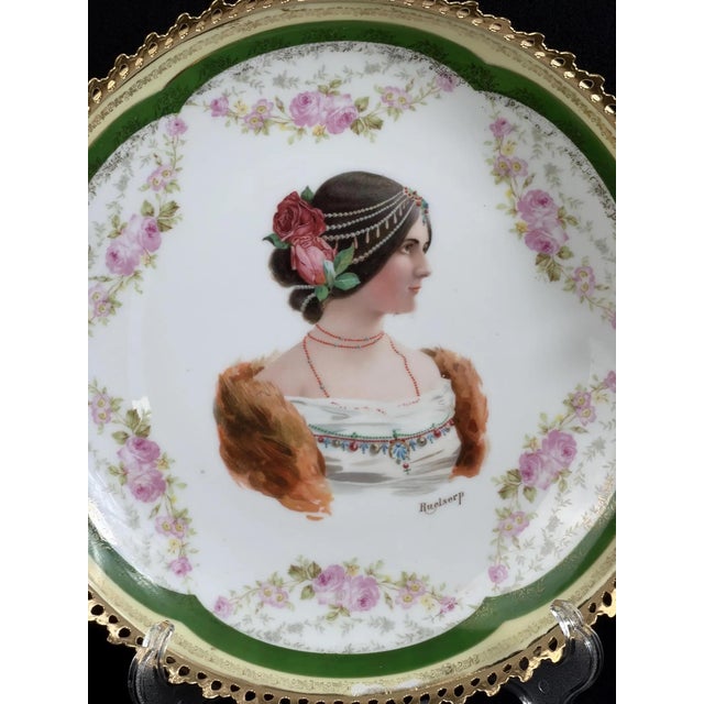 Large European porcelain decorative plate in the Vienna style, featuring a finely printed female portrait surrounded by...