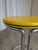 Vintage Bauhaus style side table made in the 1970s. The table features a chrome tubular steel base and a round yellow...