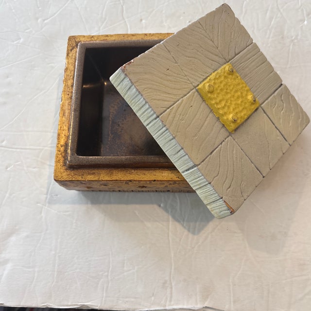 Mid Century Freeman McFarland Trinket Box that has a Bronze Bottom, Dark Bronze interior, and Beige Faux Bois Top with...