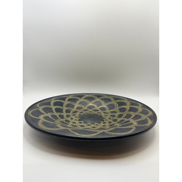 Striking vintage Japanese ceramic plate dated 1991, featuring a hand-painted black ground with gold geometric floral...