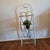 Charming vintage three-tier metal plant and display stand featuring a slender white-painted frame accented with gold-tone...