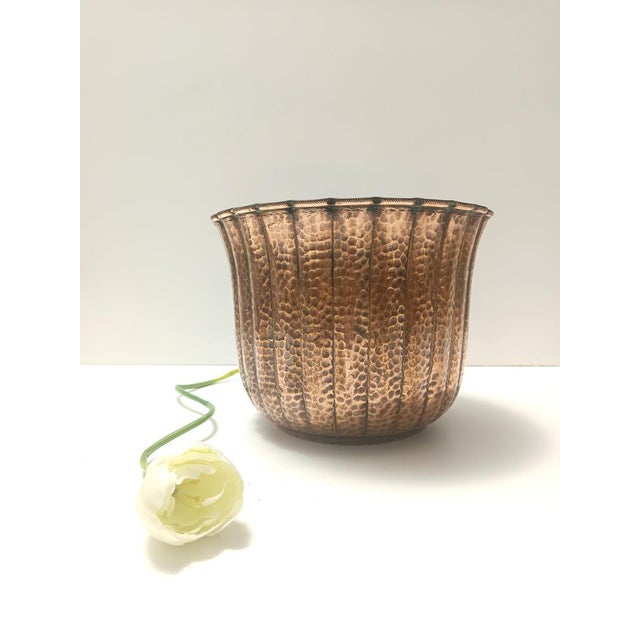 Made in Italy, 1950s. This elegant cachepot, which can also be used as a centerpiece or a vase, is made in embossed copper...