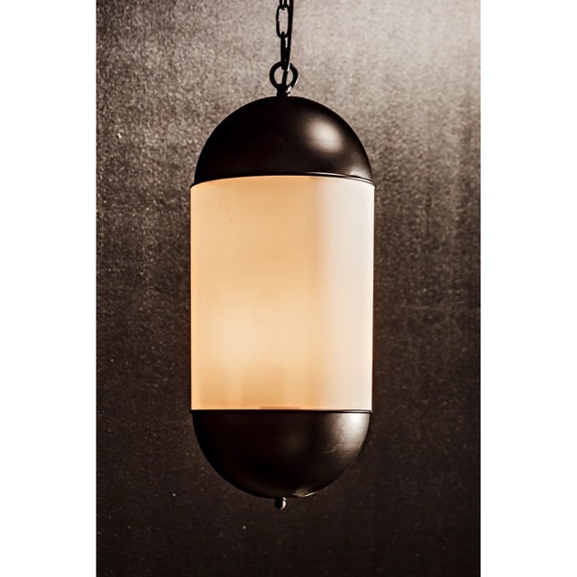 This elegant metal pendant has been expertly artisan crafted and finished in matte black and frosted glass. This lamp is a...