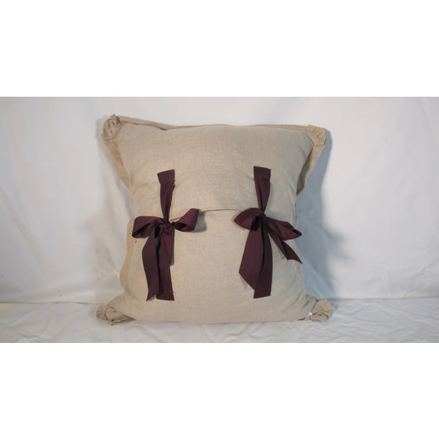 A pillow made from an early 20th century Printed cotton, with a stylized floral print, backed and edged with natural...