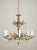 Spanish Rococo Revival crystal and brass chandelier with a gilt finish. There are ornate foliate motifs throughout the...
