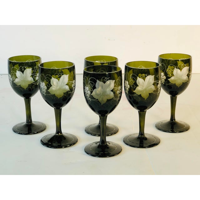 Vintage set of 6 wheel-cut green glass cordial stems with a grape leaf & vine pattern. The bases of the stems are also...