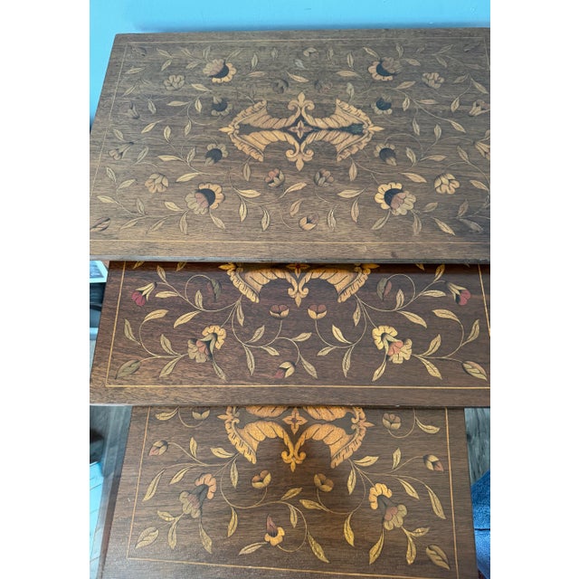 Antique mahogany nesting tables with beautiful Dutch marquetry. Crafted by Peter Engel’s out of New York. This unique...