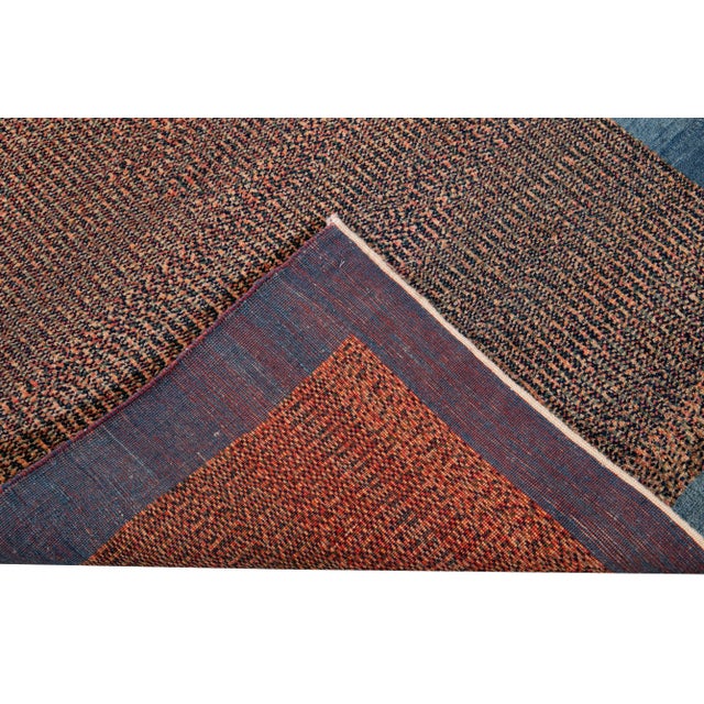 Beautiful modern Persian Gabbeh hand-knotted wool rug with a multi-color field. This piece has a blue frame and a gorgeous...