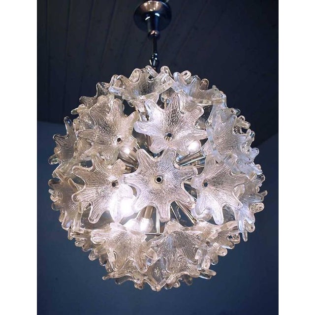 Elegant large sputnik chandelier with sixty clear murano glass flowers on a chromed frame. Designed by paolo venini....