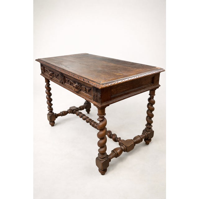 Charming small solid oak table in the Henri II style, resting on twisted legs. It features molded and carved decoration,...
