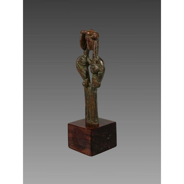 Idol, Amlash, early 1st millennium BC, bronze. Bronze group depicting two intertwined figures. Bronze with a red and green...