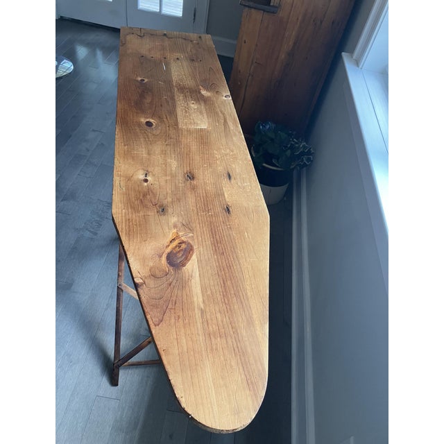 Vintage wood adjustable ironing board with two height settings creating a flexible wooden tabletop surface. • Constructed...