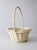Vintage painted wicker gathering basket in a soft white finish, with an open weave and arched handle. The proportions...