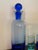 Circle ware blue cobalt glass decanter & shot glass set. The blue cobalt decanter stands 9 1/2" tall with the stopper....