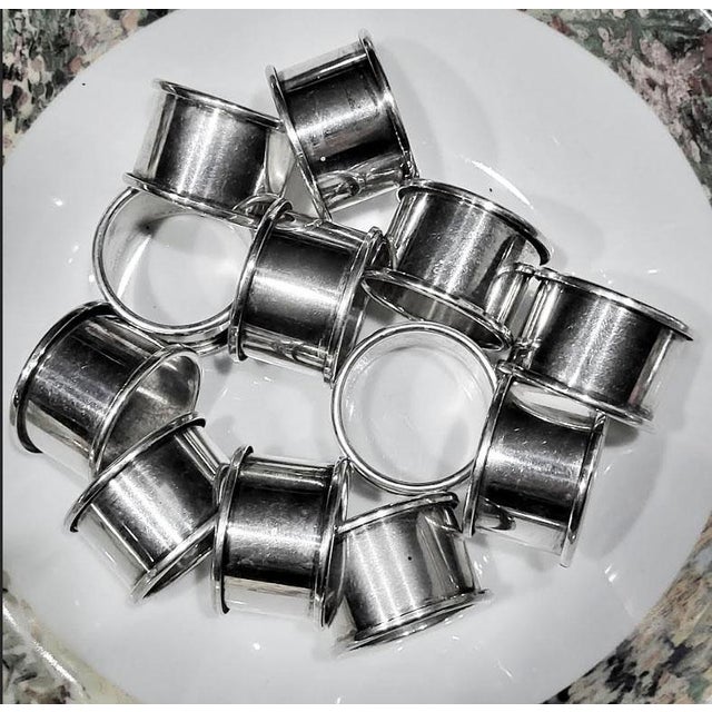 Lot of 12 vintage contemporary silverplate napkin rings. They are unmarked.