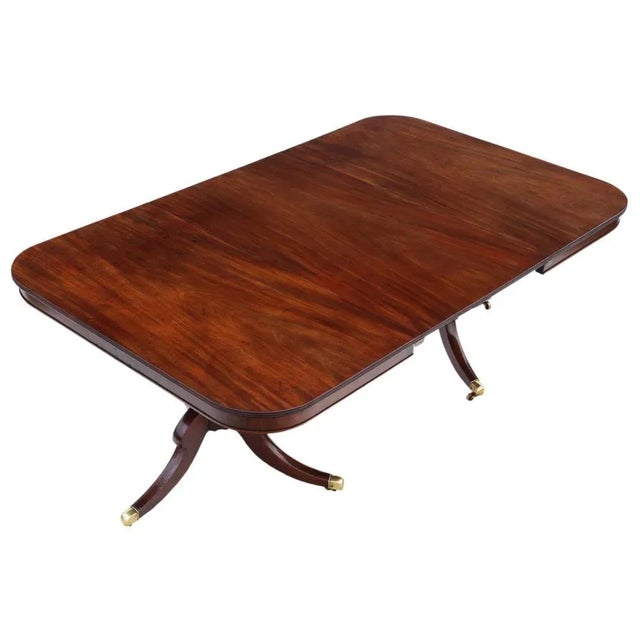 Antique large fine quality mahogany extending twin pedestal extending dining table early 19th Century. The table has a...