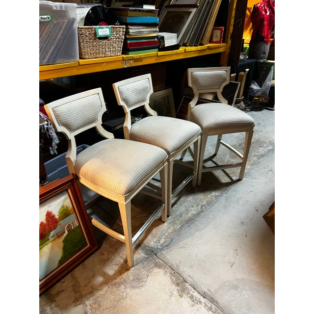 Up for consideration is a beautiful vintage trio of white wooden barstools with cushions. These would look lovely in your...