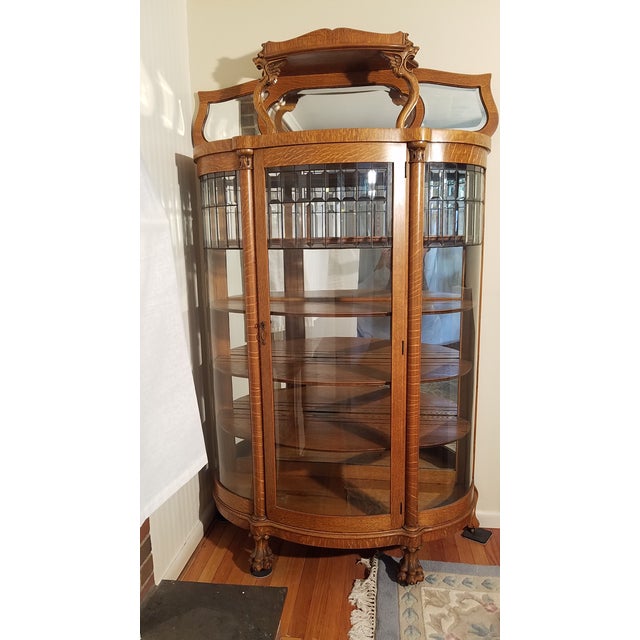 Large Victorian Oak Curved Front Curio c. 1890-1920. This Large Ornate Golden Tiger Oak Curio has three glass bows with...