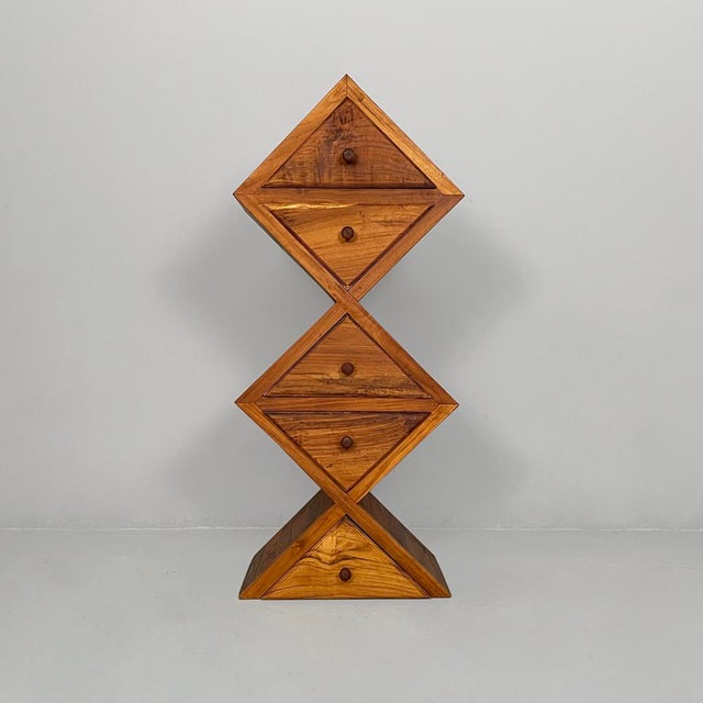 Italian modern geometric wooden chest of drawers, 1980s Chest of drawers made entirely of solid wood. The vertical...