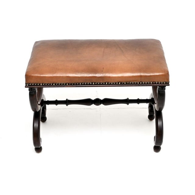 A wonderful antique Regency period leather stool. This was made in England, it dates from around the 1815-1830 period. It...