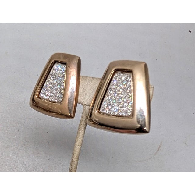 1980s goldtone trapezoid-shaped with pavé round clear rhinestones in the center clip earrings. Marked "PANETTA" on the...