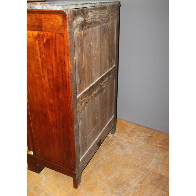 Empire chest of drawers with detached columns in cherry wood, it opens with seven drawers, gray marble top, varnished...