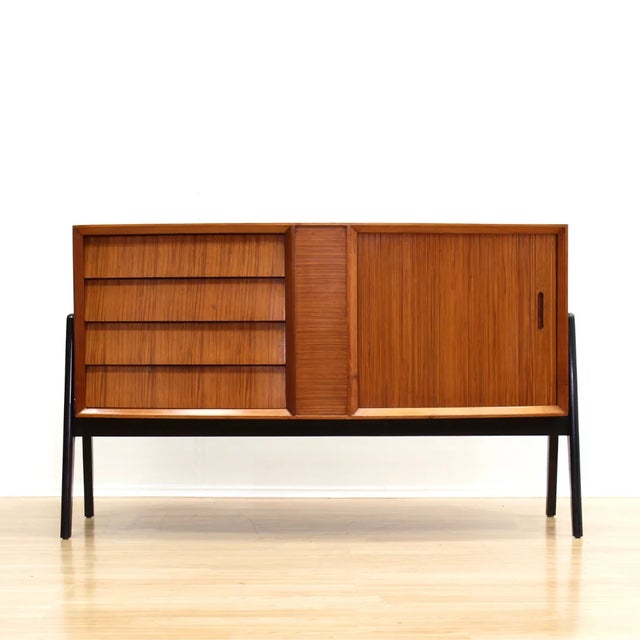 A rare, beautifully styled and exquisitely detailed 1950s sideboard manufactured by Herbert Gibbs, England. This vintage...