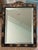 Antique diminutive scale English dressing mirror constructed with a black lacquer frame decorated by hand in gilt and...