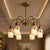 Elevate your interior with this elegant Modern 6 Light Brass Chandelier, designed to bring together sculptural form, warm...