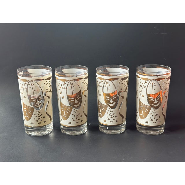 The classic comedy and tragedy mask motif on this set of vintage mid-century modern cocktail glasses will make a dramatic...