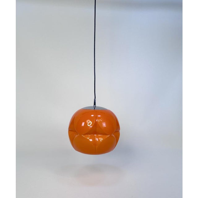 This high-quality colored opaline glass hanging lamp was manufactured by peill & putzler in germany during the late 1960s...