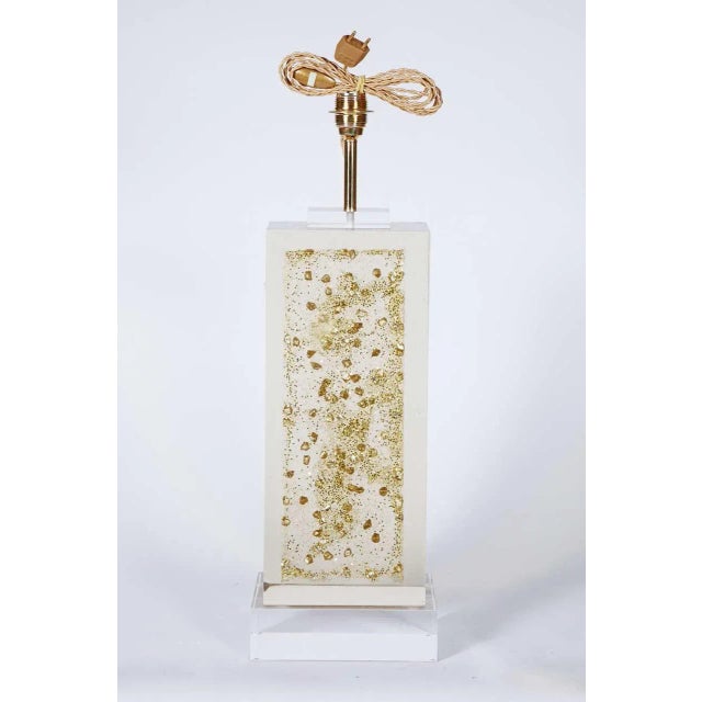 These Lucite lamps with golden inclusions were produced in the 1970s. Up to 250V (Europe/UK Standard).The wiring of this...