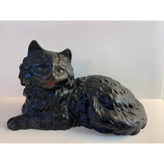 Vintage fireplace cat or door stop cast made of cast iron and painted black with green eyes. Cast from the original Hubley...
