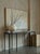A striking black iron console table that brings industrial elegance to any entryway or living space. Its sturdy metal...