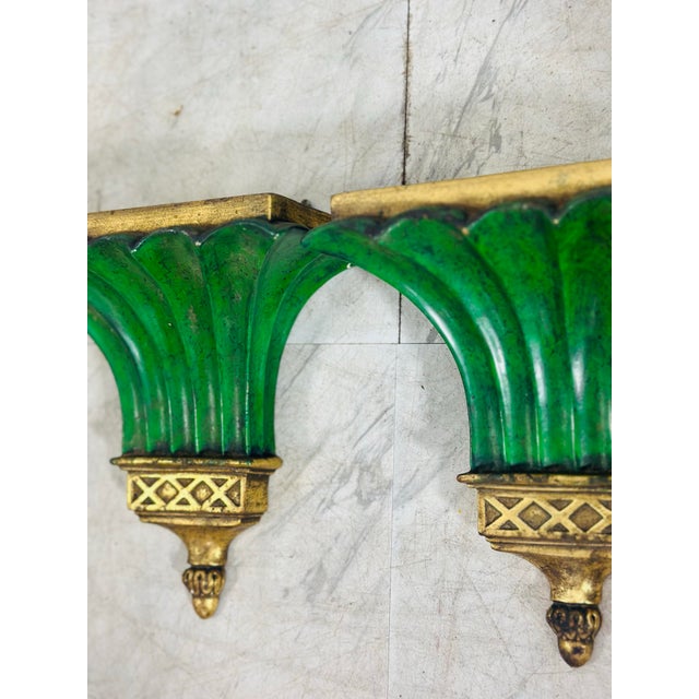 This striking pair of vintage wall brackets or display shelves features a dramatic neoclassical-inspired design with...