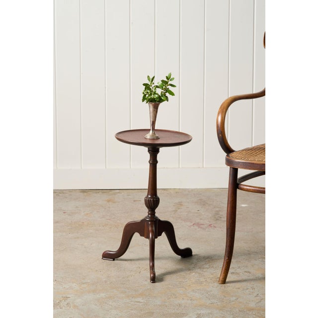 This antique English mahogany wine table brings warmth and character to any room, offering a charming spot for a drink...