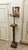 An elegant pair of decorative pedestals made of red marble with a distinctive pattern. Each column is decorated with brass...