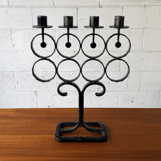 A Swedish cast iron candelabrum designed by Bertil Vallien for Boda Smide. The piece is built around a repeating...