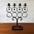 A Swedish cast iron candelabrum designed by Bertil Vallien for Boda Smide. The piece is built around a repeating...