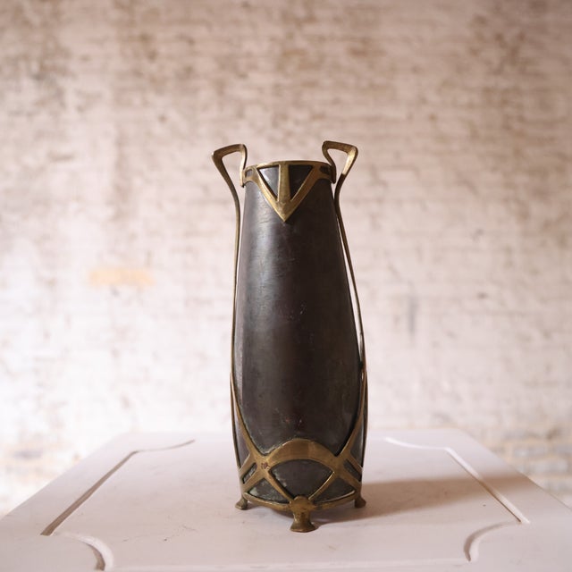 A 19th-century French Art Nouveau vase crafted in glass, characterized by its fluid lines and organic form. The design...