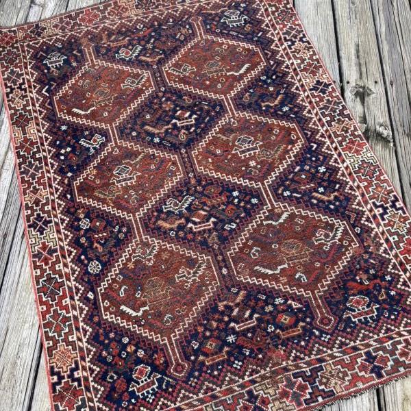 An Authentic Antique QashqaiTribal Rug Hand-knotted nearly 90 years ago by nomadic artisans, this antique rug reflects the...