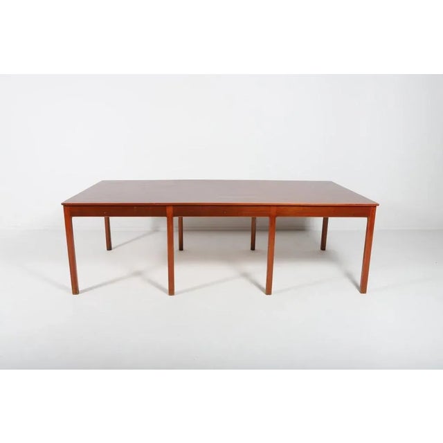 Spectacular mahogany-teak table by Ejner Larsen & Aksel Bender Madsen for Willy Beck / Morten Olsen. The distinguishing...