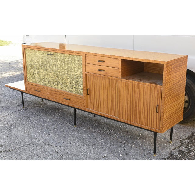 Sideboard with flap door decorated with a stlizzato design of a bamboo forest in black on yellow background accompanied by...